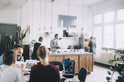 Creative male and female entrepreneurs working in office