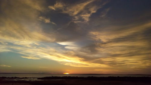 Scenic view of calm sea at sunset