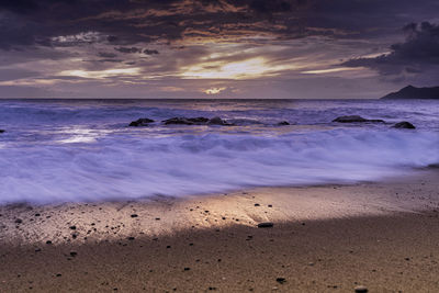 Scenic view of beach against sky during sunset