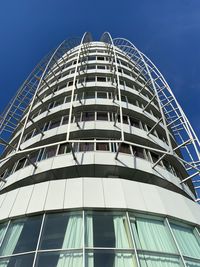 Low angle view of modern building against clear blue sky