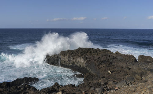 Waves breaking against sea