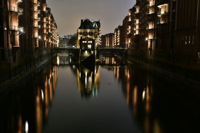 Reflection of illuminated buildings in canal at night