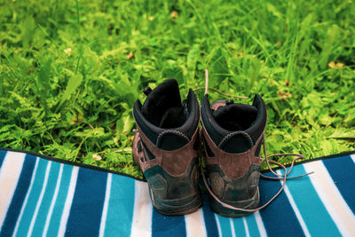 Hiking boots on a picnic blanket in the meadow.