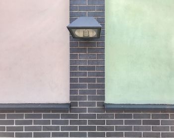 Lamp on wall of building