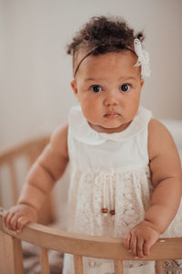 Portrait of cute baby girl at home