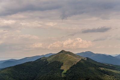 Scenic view of mountain against cloudy sky