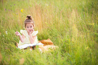 Boy sitting on field