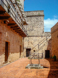 Staircase by building against sky