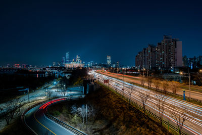 High angle view of light trails on road in city