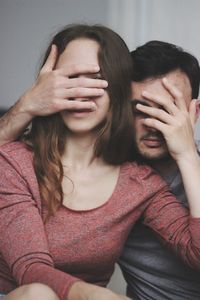 Young couple covering face