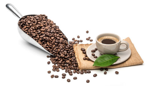 High angle view of coffee beans against white background