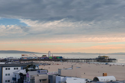 High angle view of buildings by sea against sky