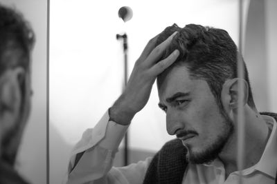 Close-up of man reflecting in mirror