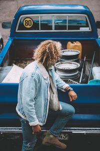 Midsection of woman sitting in car