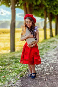 Portrait beautiful brunette girl holding a craft bag with french baguettes.