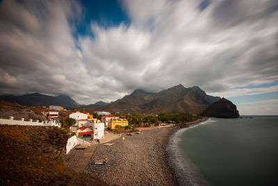 Scenic view of sea and buildings against sky