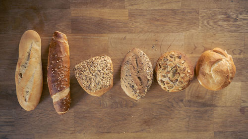 Flat lay of selection of a variety of different buns, rolls and sticks from bakery 