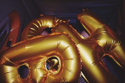 Close-up of helium balloons in darkroom