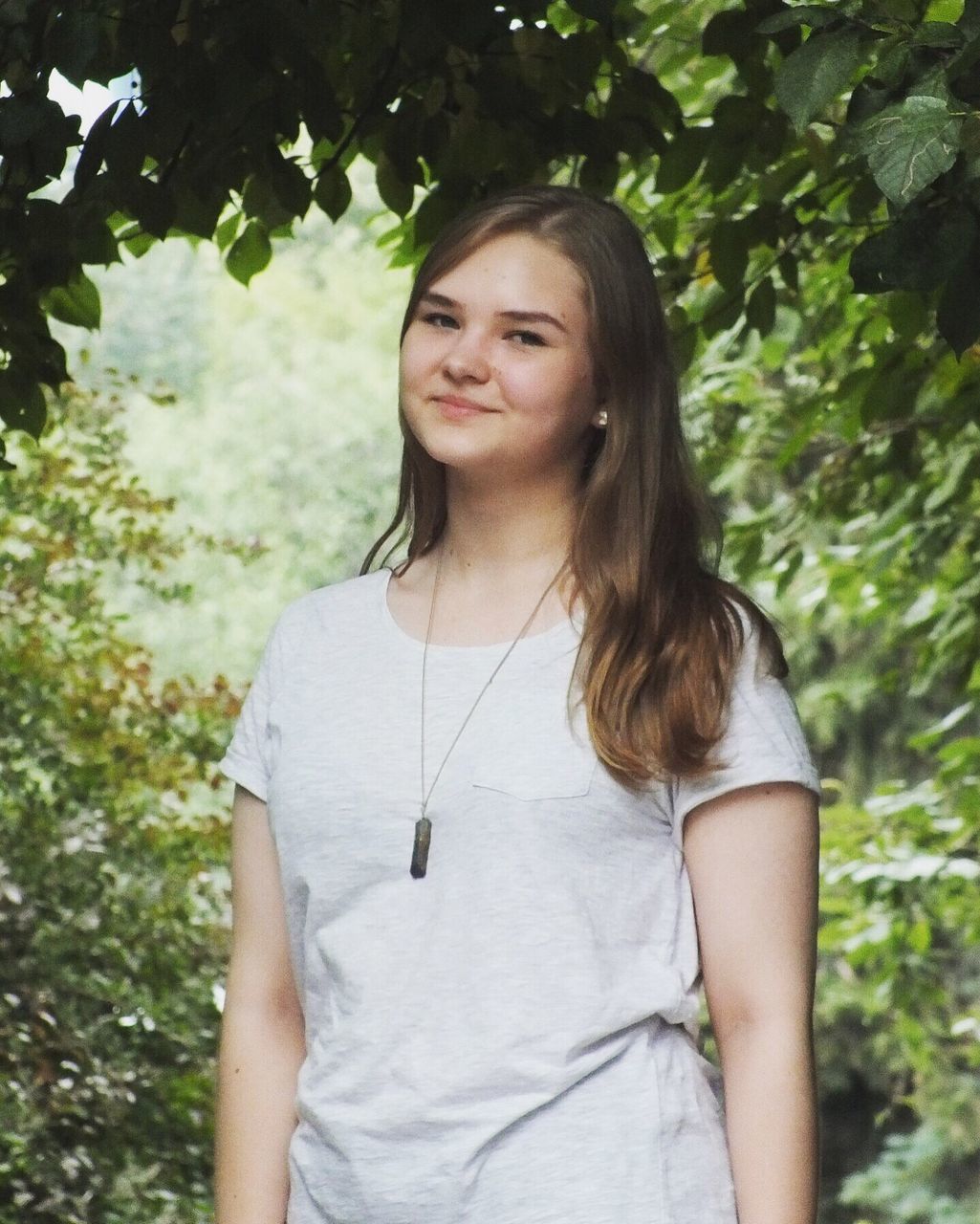 young women, long hair, lifestyles, portrait, casual clothing, leisure activity, tree, beauty, black hair, outdoors, day, plant, nature, contemplation, growth, focus on foreground