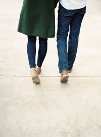 Low section of people walking on tiled floor