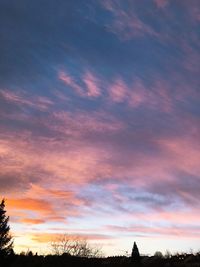 Scenic view of dramatic sky over silhouette landscape