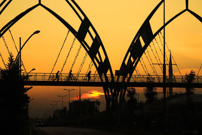 Silhouette bridge against sky during sunset