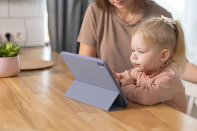 Young woman using laptop at table