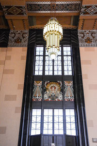 Low angle view of building seen through glass window