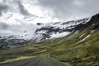 Scenic view of mountains against cloudy sky