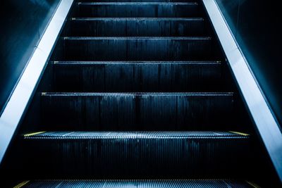 Low angle view of illuminated escalator