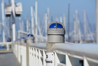 Close-up of metal railing against sea