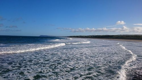 Scenic view of sea against blue sky