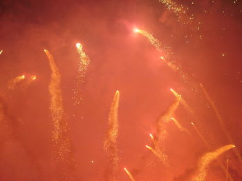 Low angle view of firework display at night