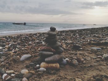 Pebbles on beach against sky