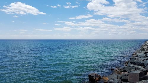 Scenic view of sea against cloudy sky