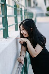 Portrait of smiling young woman standing outdoors