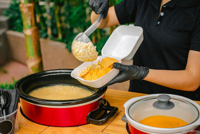 Midsection of man preparing food