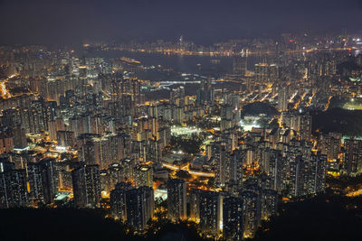 High angle view of illuminated cityscape against sky at night