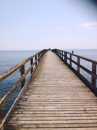 Pier over sea against sky
