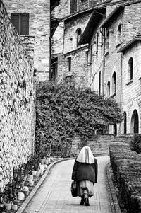 Rear view of woman walking on street