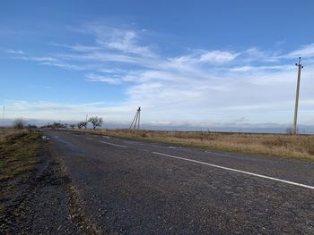 Empty road along countryside landscape