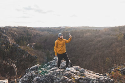 Rear view of man standing on mountain