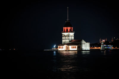 Illuminated building against sky at night