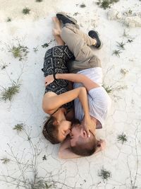 High angle view of couple lying on floor