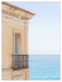 View of building against horizon over sea