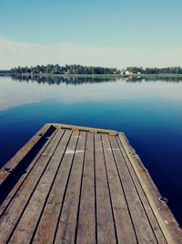 View of swimming pool by lake against sky