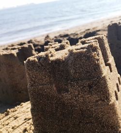 Close-up of sandcastle on beach