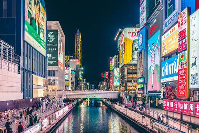 Reflection of illuminated buildings in city river at night