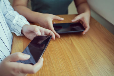 Midsection of man using mobile phone