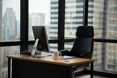 Chair and table against window in office